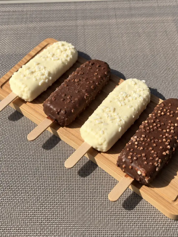 Picolés cobertos de chocolate ao leite e branco